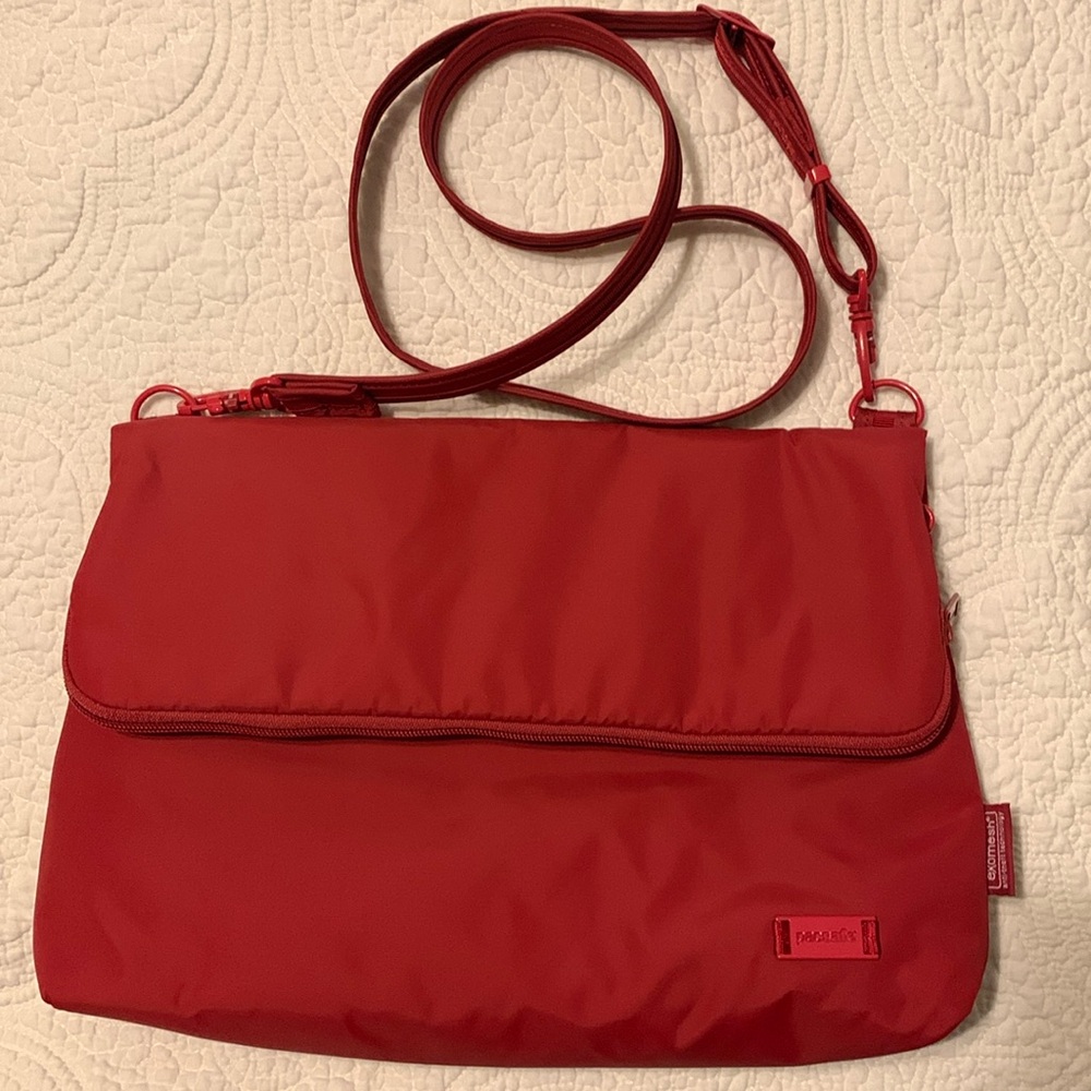 Pacsafe anti-theft fold-over Crossbody bag. Red